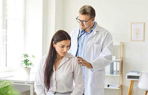doctor con estetoscopia revisa estado de salud de mujer